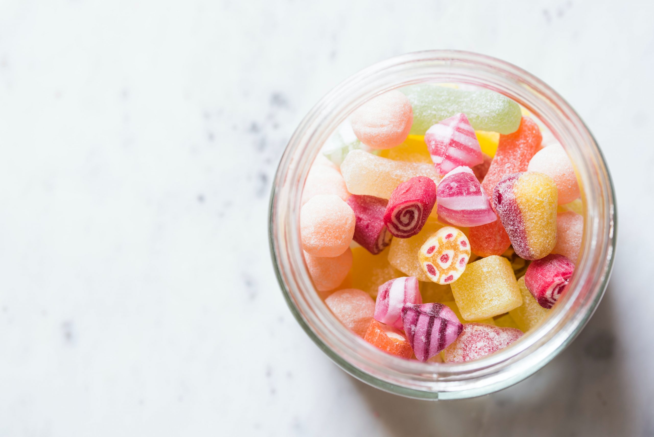 jar of sugary sweets on a white tabletop