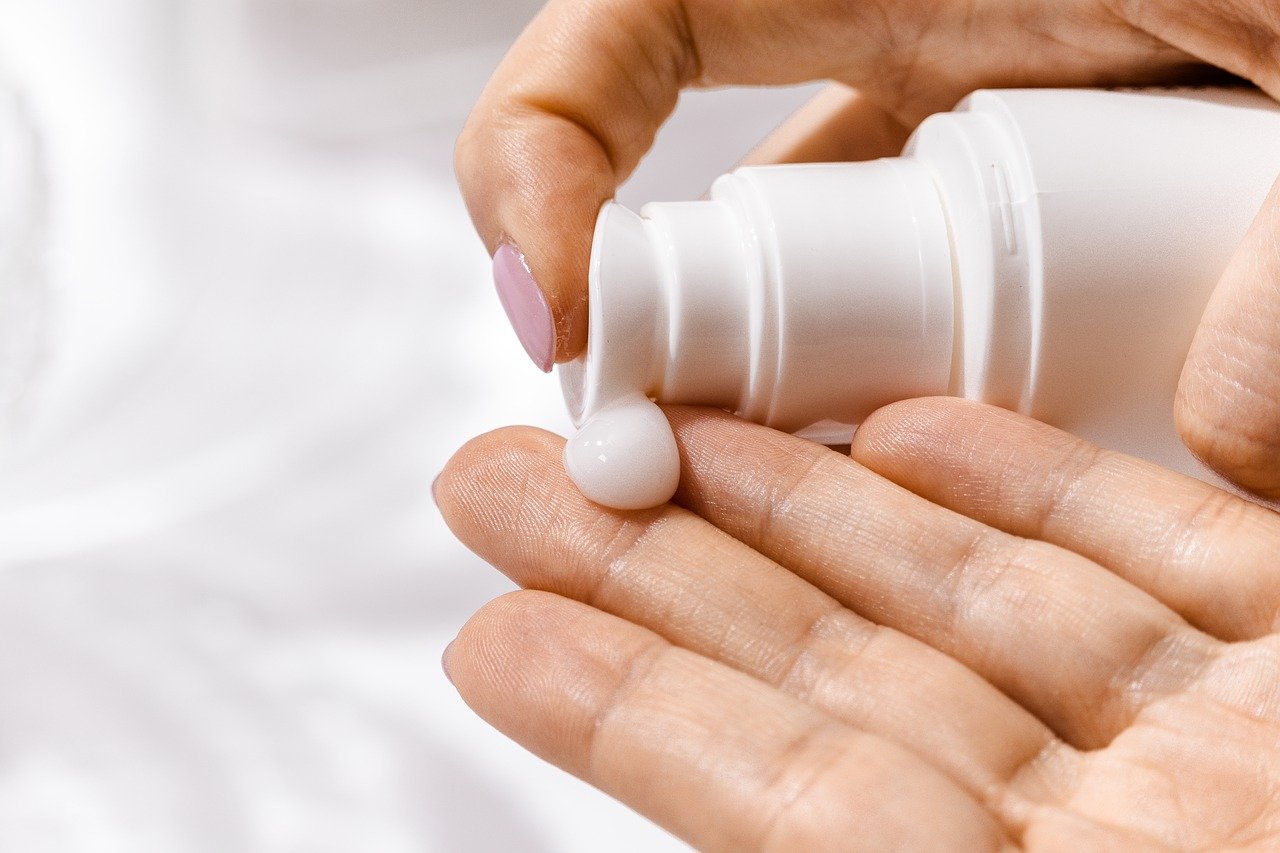 cleanser being squirted from tube onto fingertips