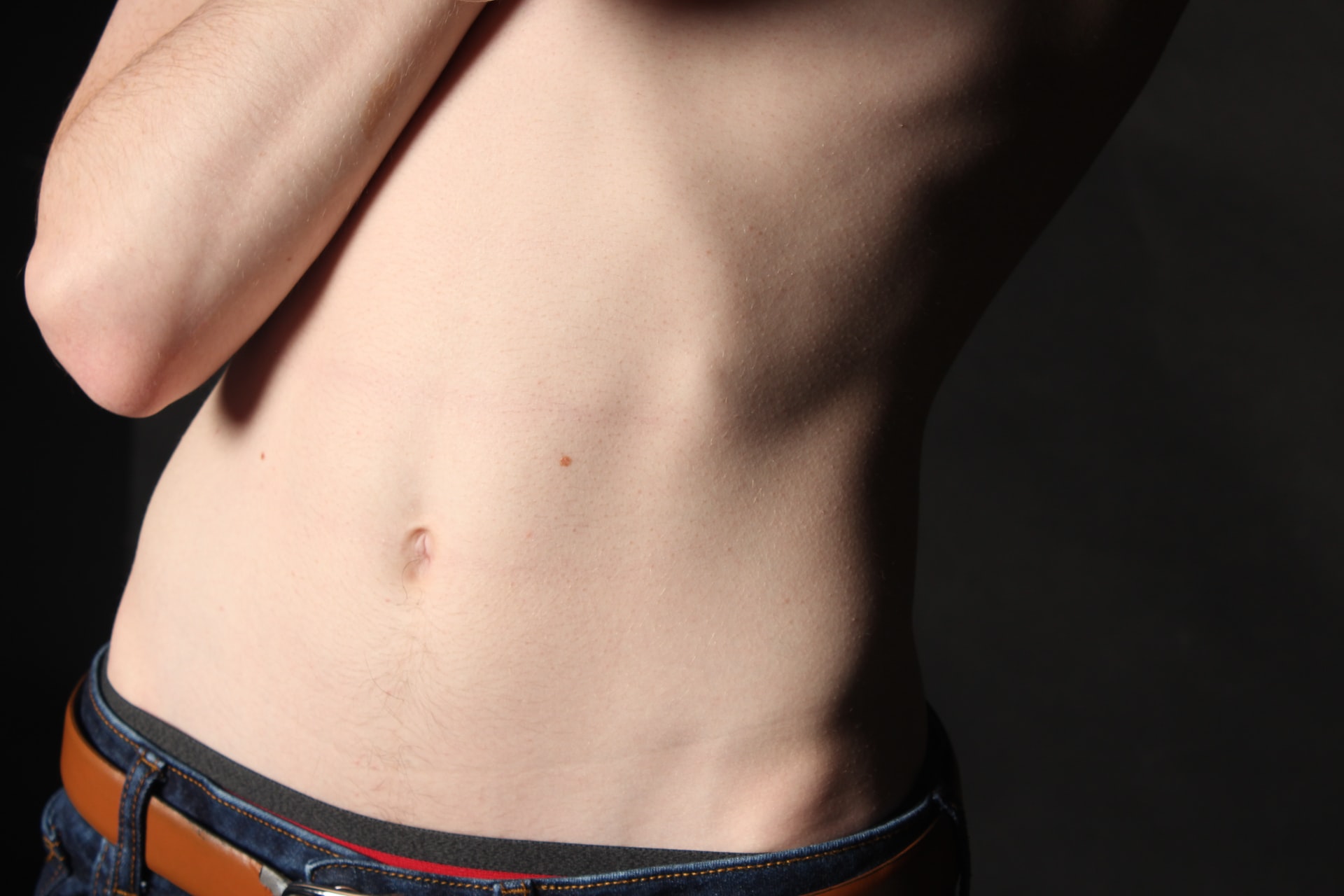 close-up of person with flat stomach, emsculpt results potential