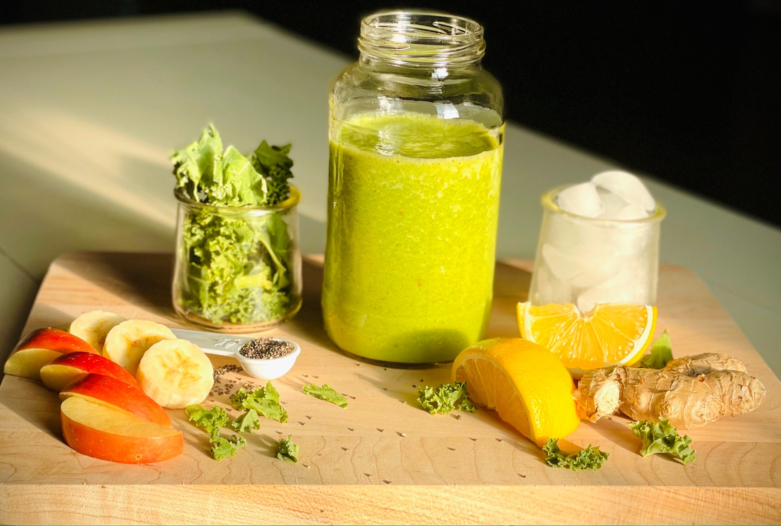 fruit portions on wooden board next to jar with fruit juice