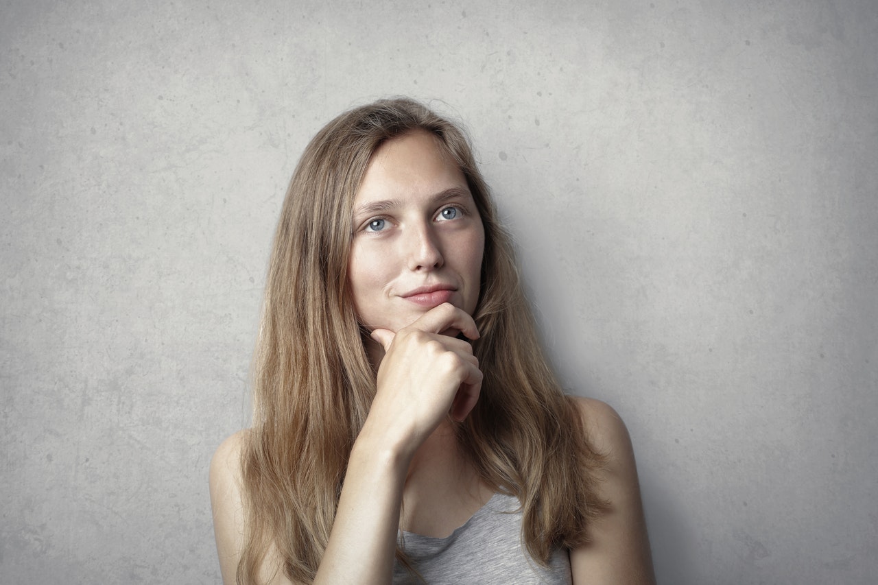 woman thinking, hand on chin