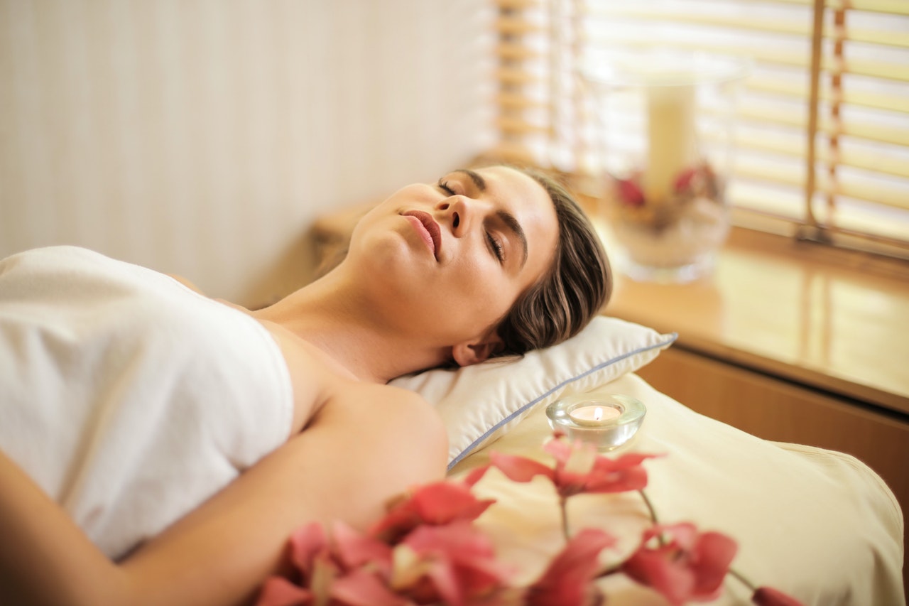 person lying down in relaxing setting, awaiting chemical peel skincare treatment