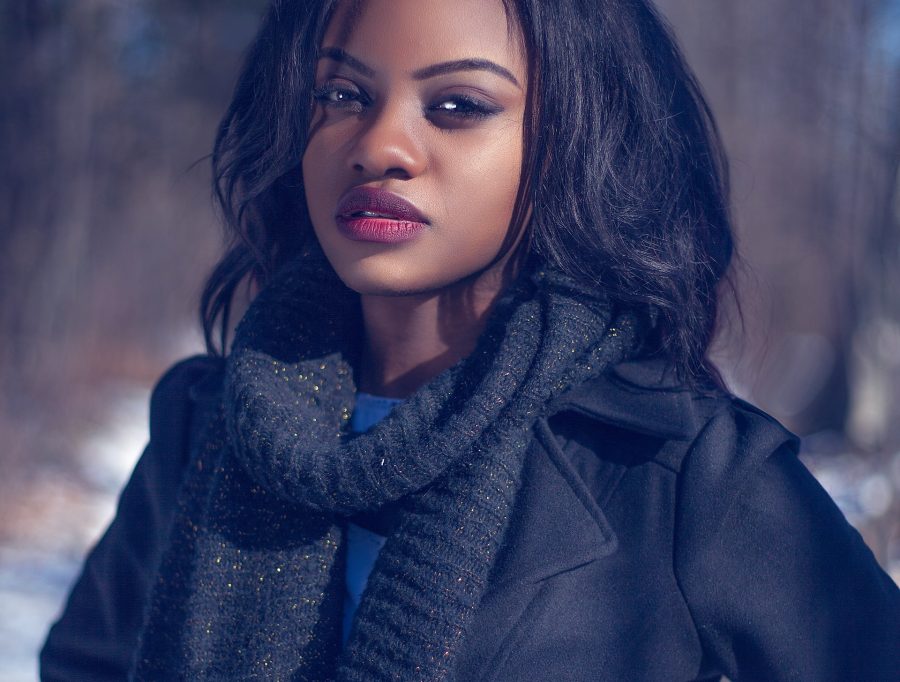 person standing against a snowy background, dark skin and full, beautiful lips, how does lip augmentation work, lip fillers