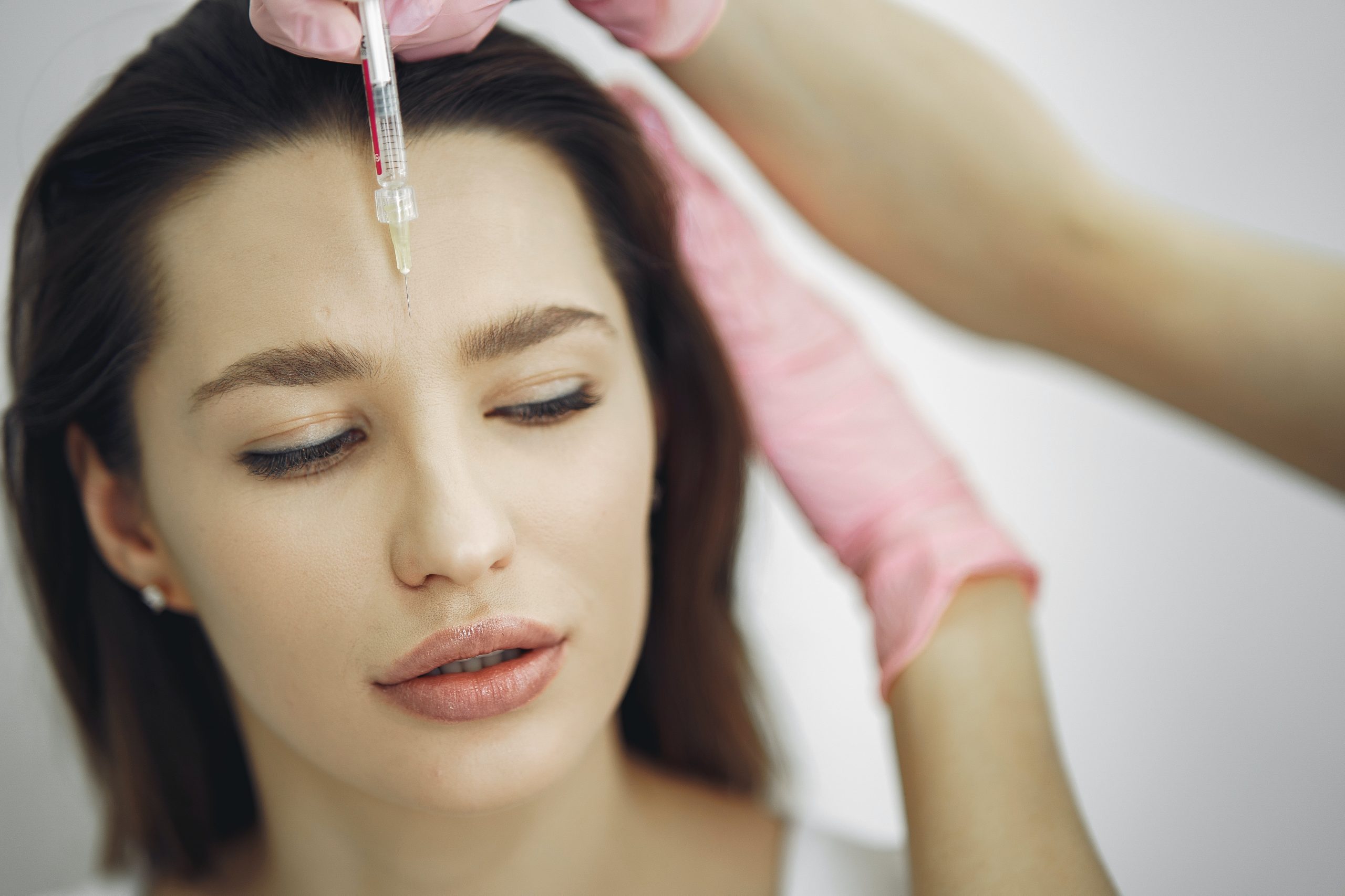 woman receiving dermal filler in face