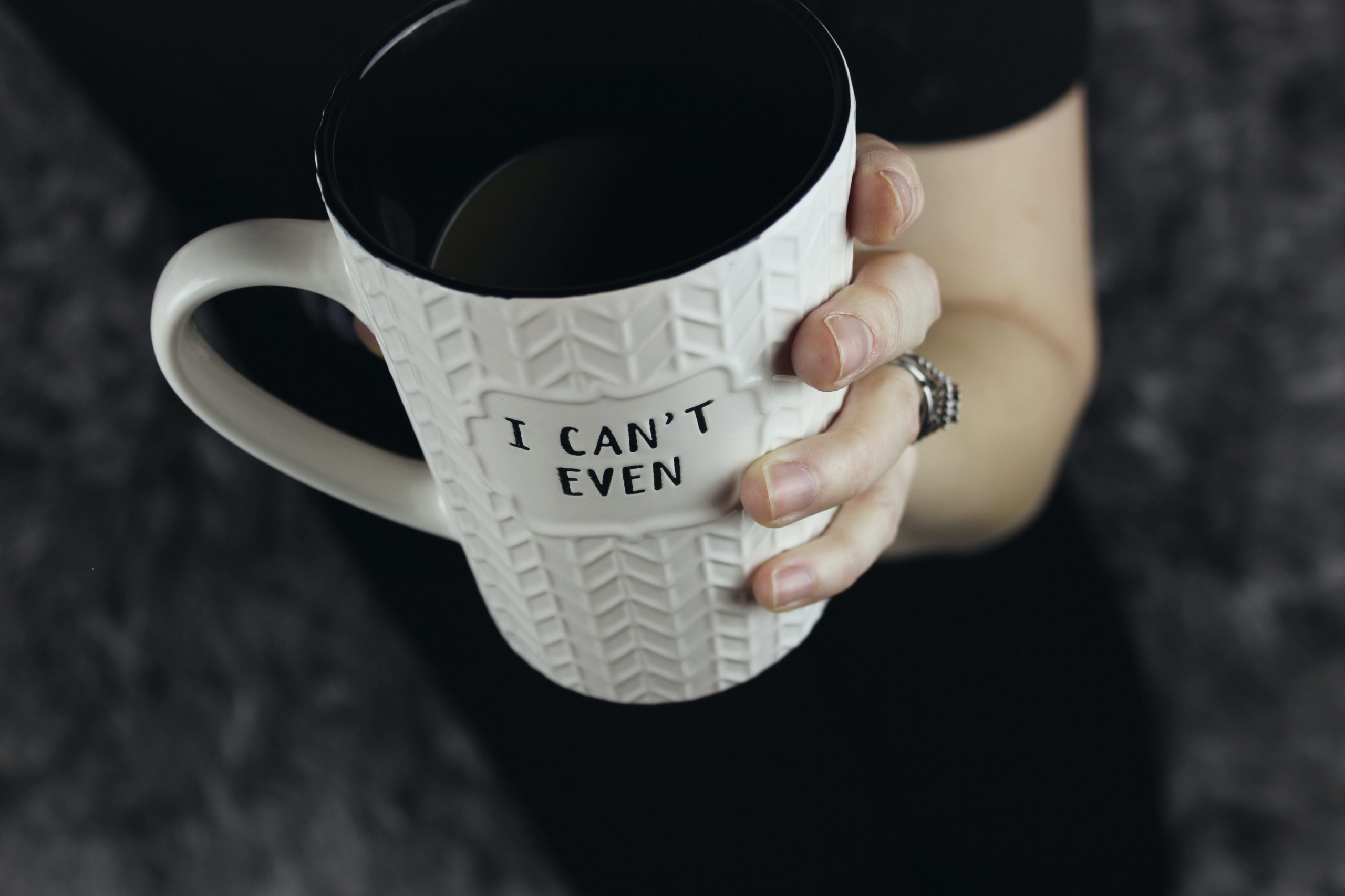 hand holding giant coffee cup