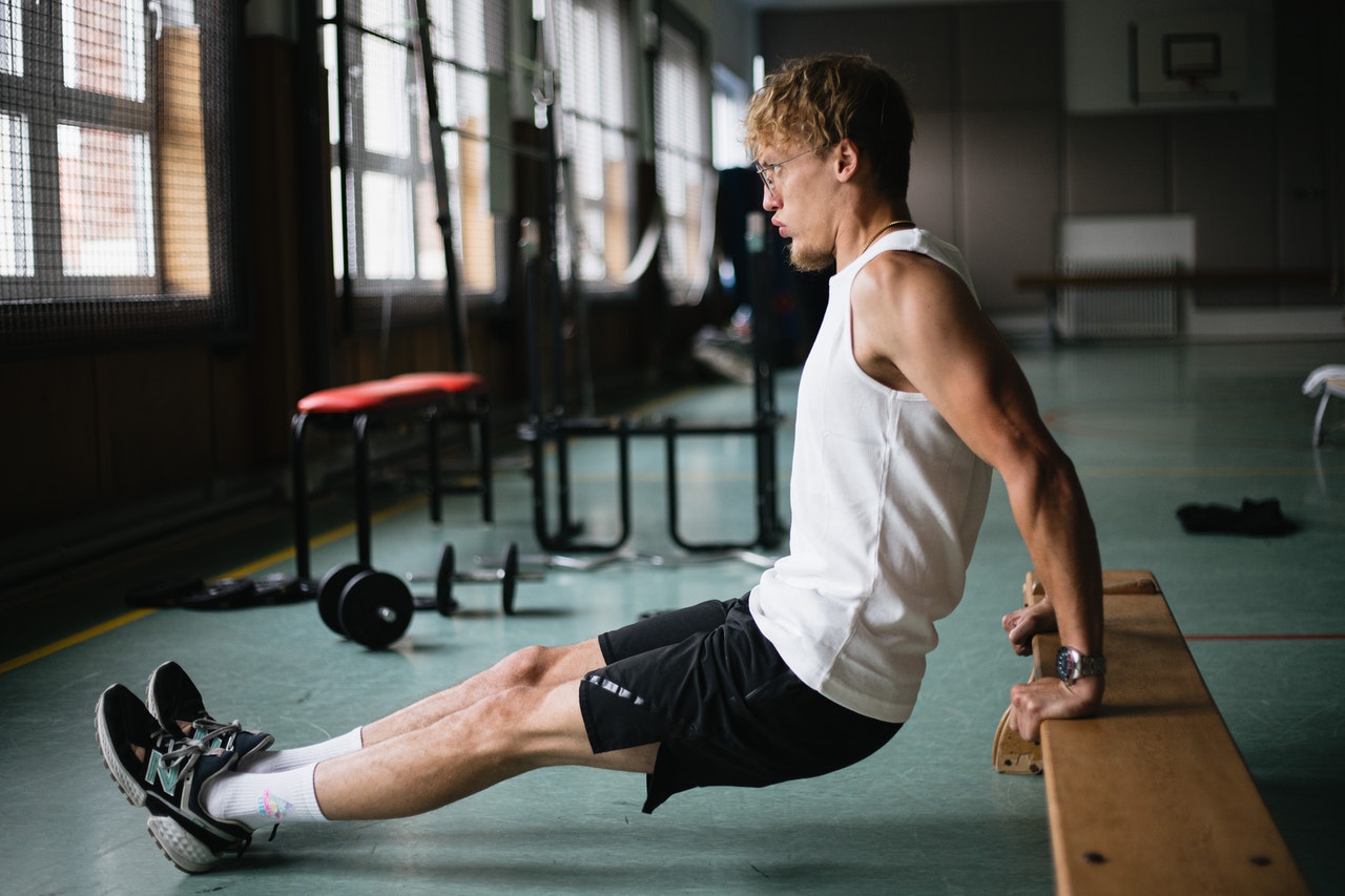 person doing tricep dip on a bench