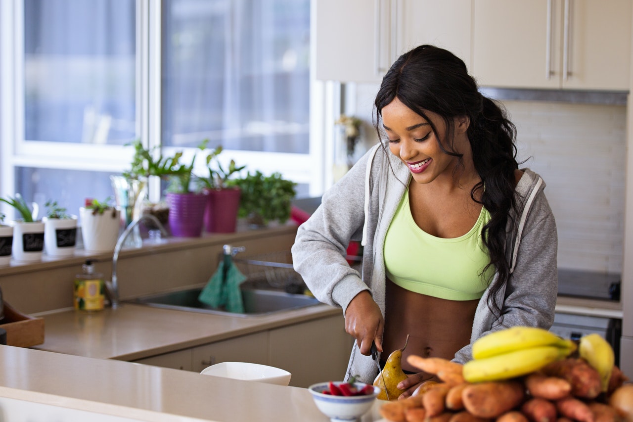 healthy person in kitchen preparing healthy, vitamin-rich food