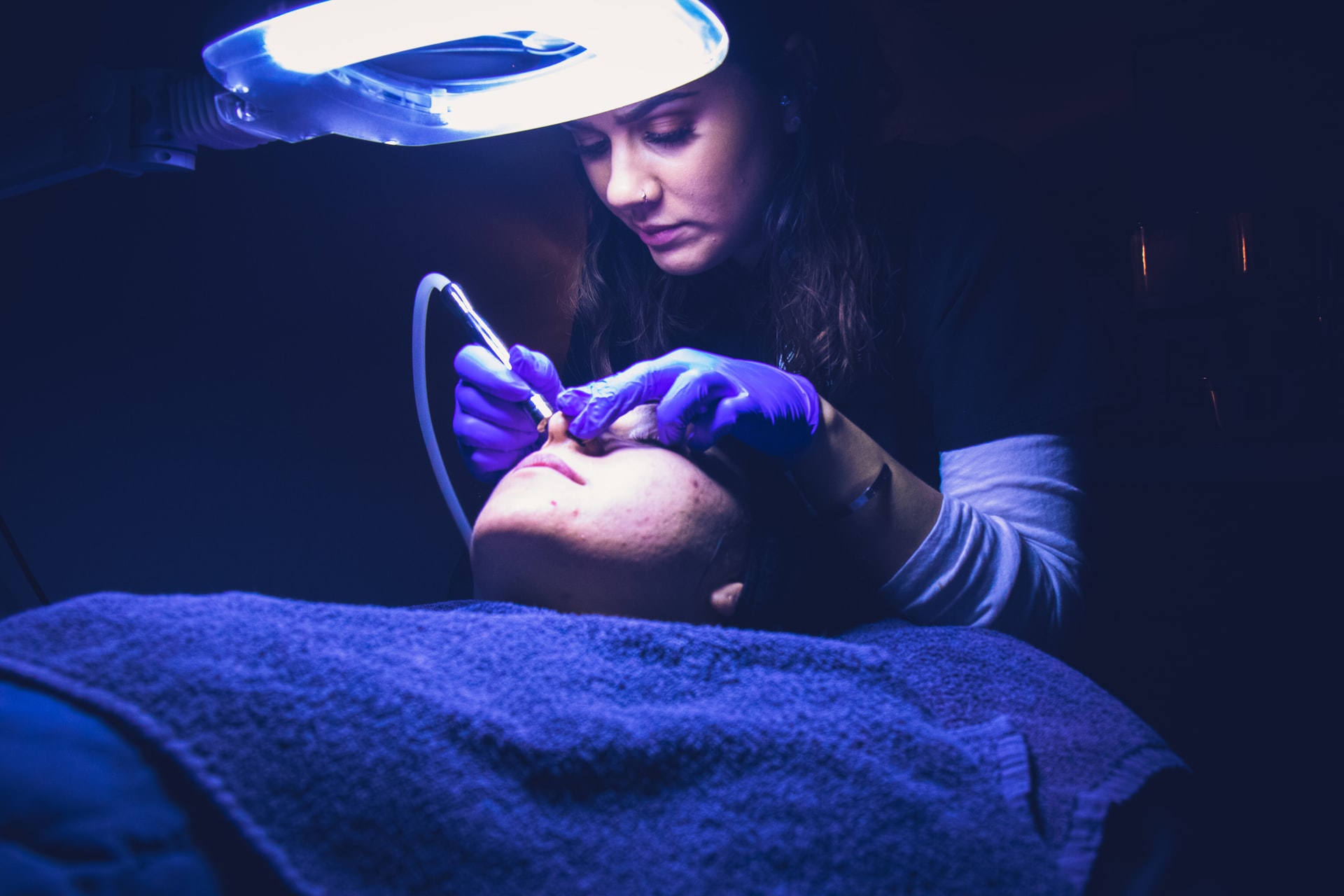 person receiving microdermabrasion treatment, skin resurfacing methods